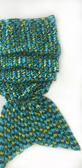 crochet mermaid tail in shades of green blue and yellow