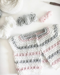 Work in progress of Crochet Baby Sweater in White, Pink and Gray - flat lay, no sleeves