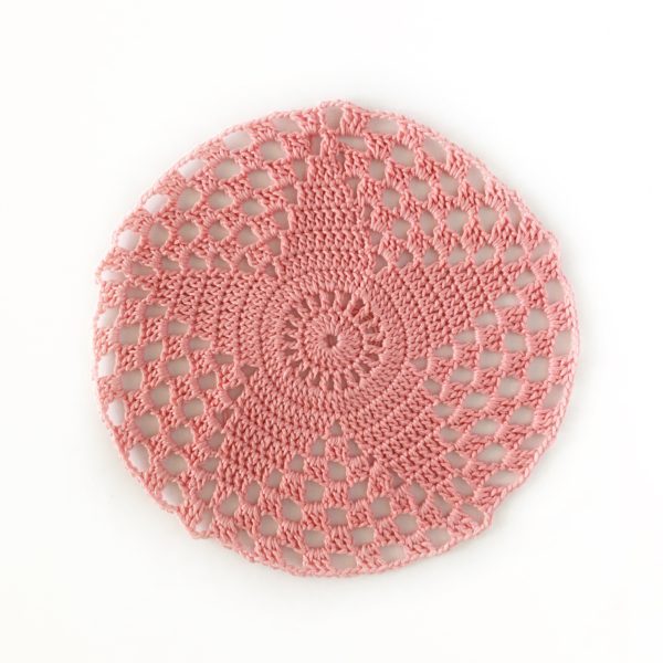 pink crochet star in circle on white background