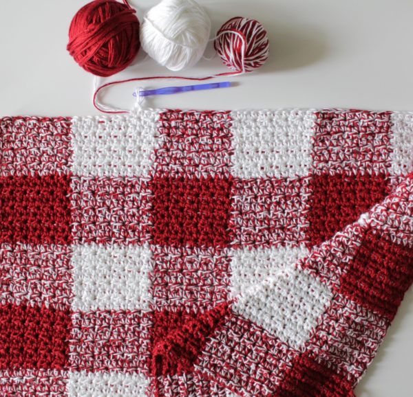 Crochet Red Gingham Blanket laying flat with yarn