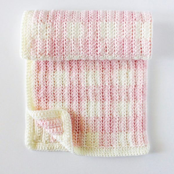 Crochet Light Pink Gingham Blanket rolled and folded