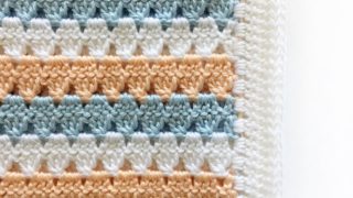 Peach blue and white Crochet Modern Granny Blanket folded