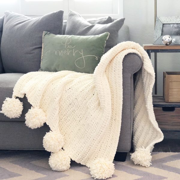 crochet pom pom blanket on couch