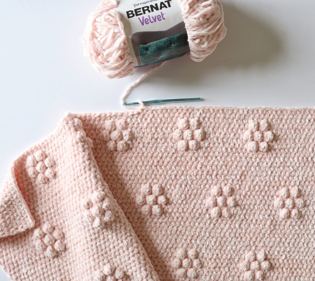 pink crochet blanket with puff flowers