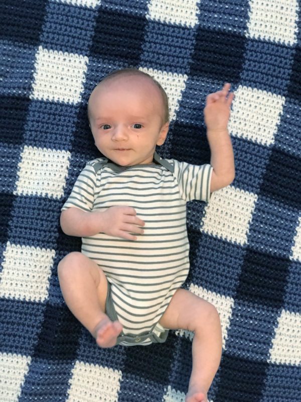 baby boy on blue gingham blanket