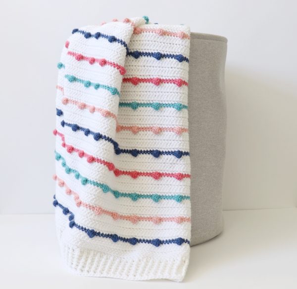 Crochet Bobble Lines Baby Blanket in basket