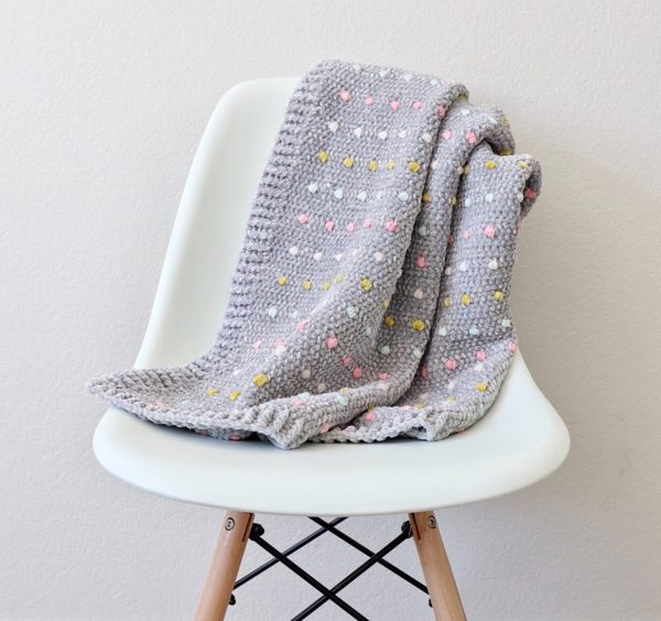 Crochet Candy Dots Baby Blanket on chair