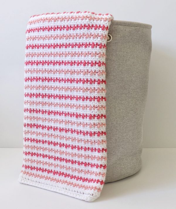 Crochet Puff Stripes Baby Blanket on basket