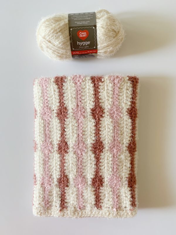 hygge friendship blanket folded with yarn