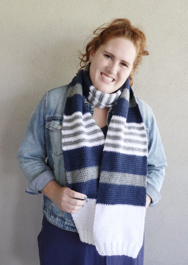 girl wearing blue white and gray crochet scarf