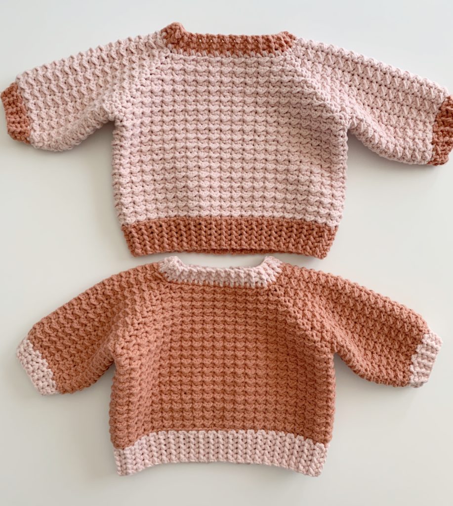 2 pink crochet baby sweaters