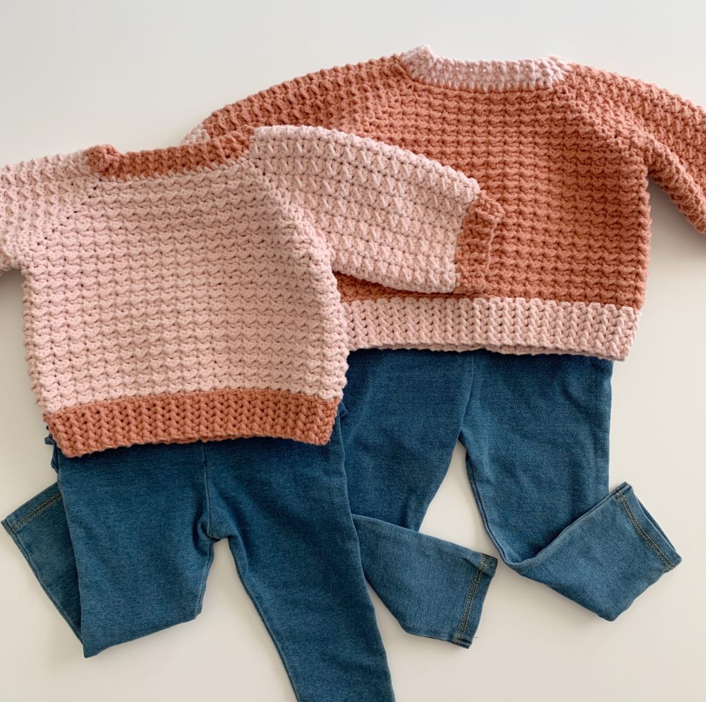 two crochet sweaters with baby jeans