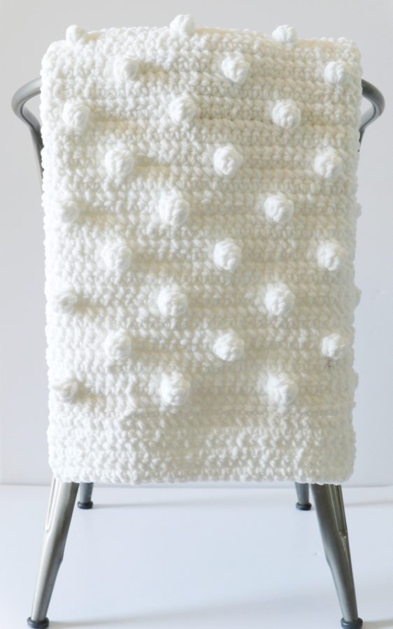 white polka dot blanket on chair