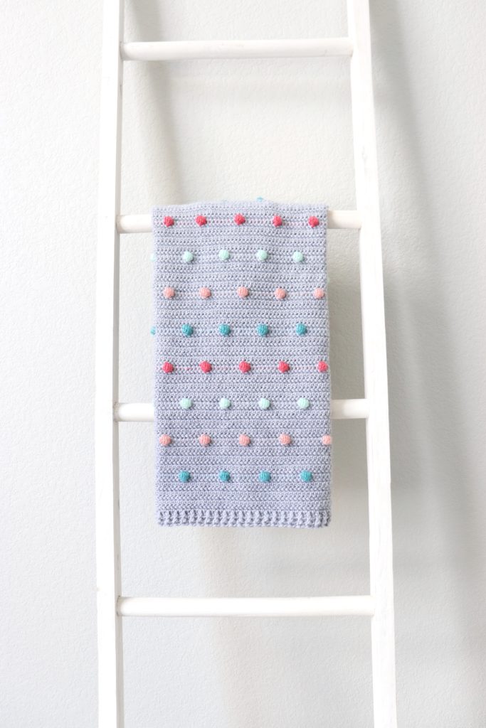 colorful polka dots crochet blanket on ladder
