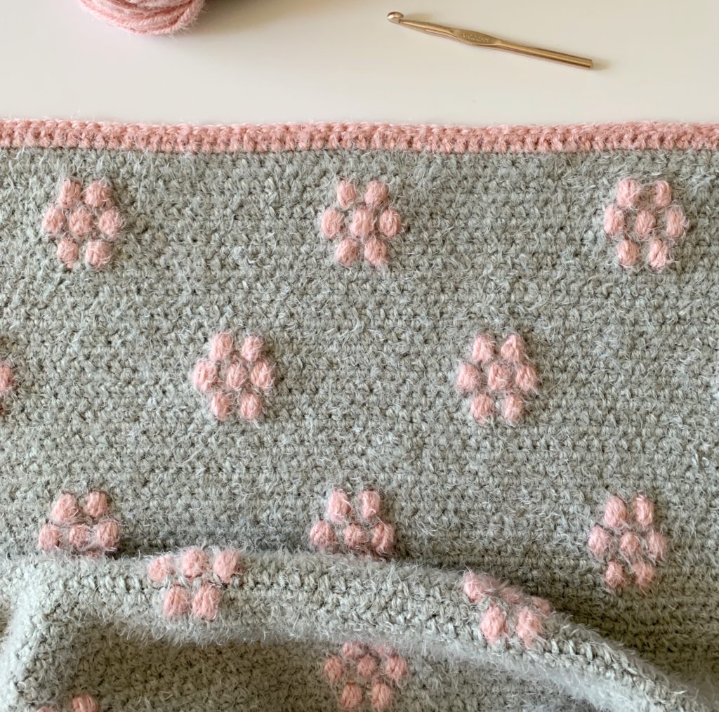 gray blanket with pink flowers
