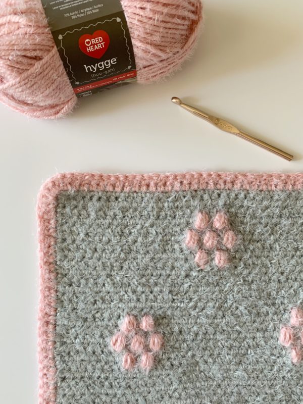 gray blanket with pink flowers