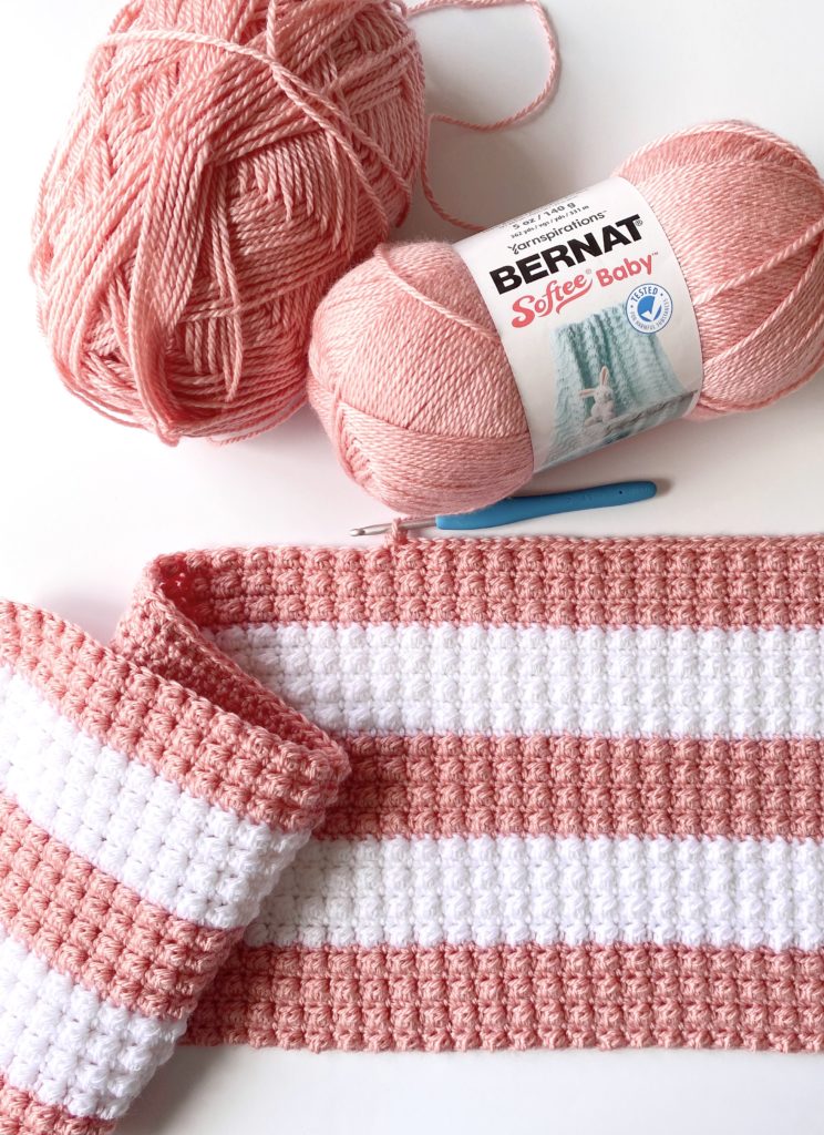pink and white striped crochet blanket in progress
