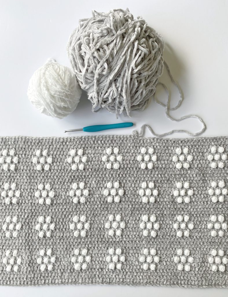 gray and white flowers blanket in progress
