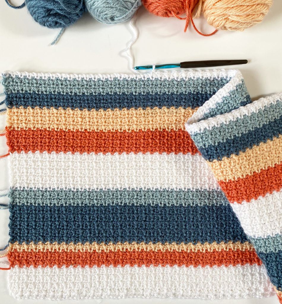 orange blue shades striped crochet blanket in progress