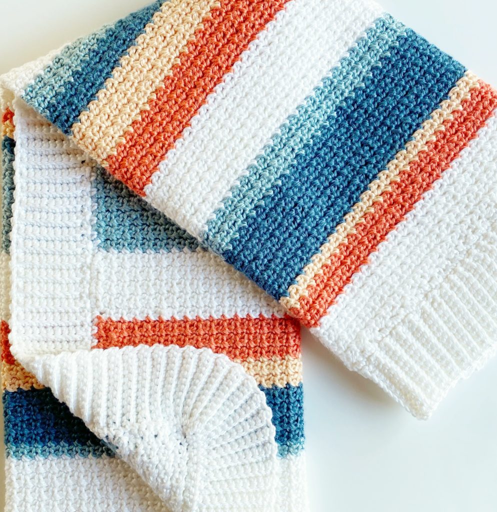 orange and blue shades striped crochet blanket folded