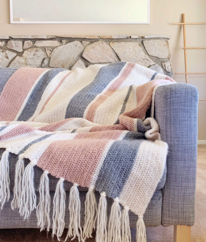 pink gray cream mixed stripes crochet throw on couch