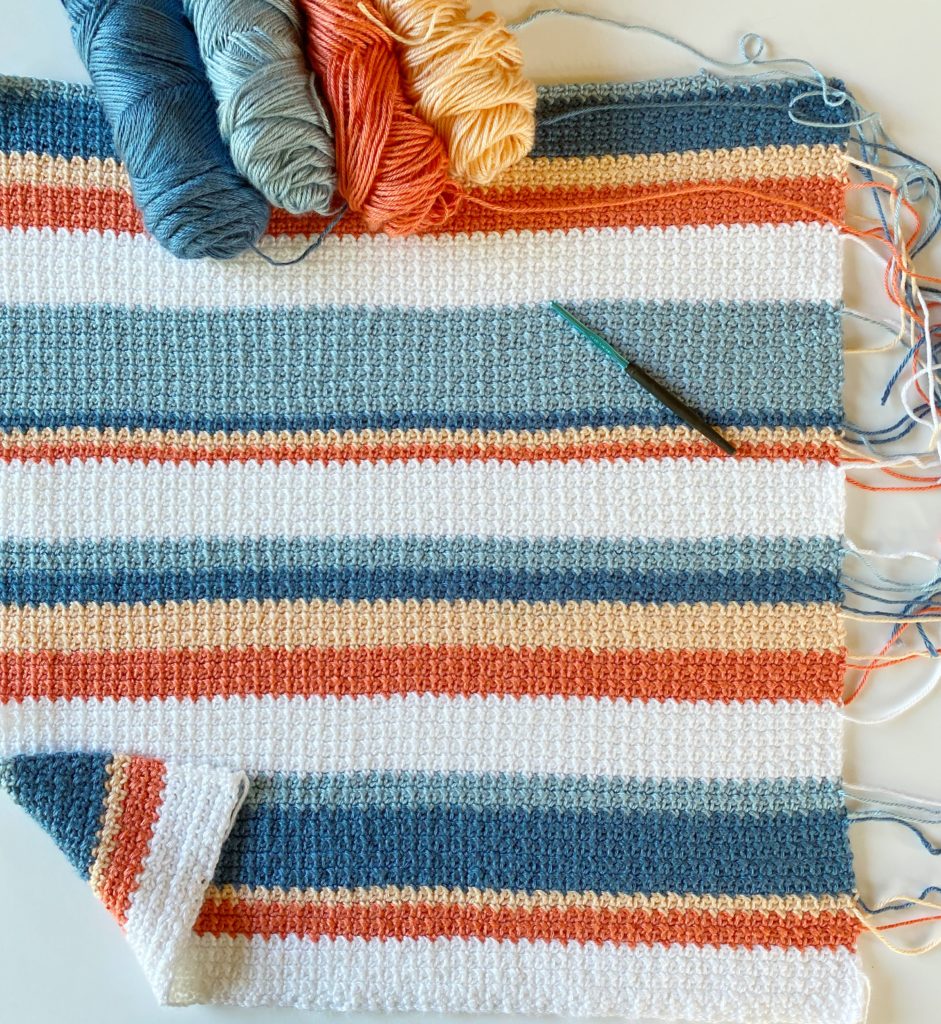 orange and blue shades striped crochet blanket in progress