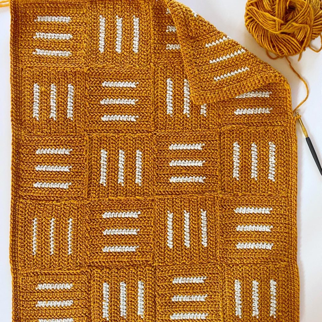 gold crochet blanket with white hatch lines