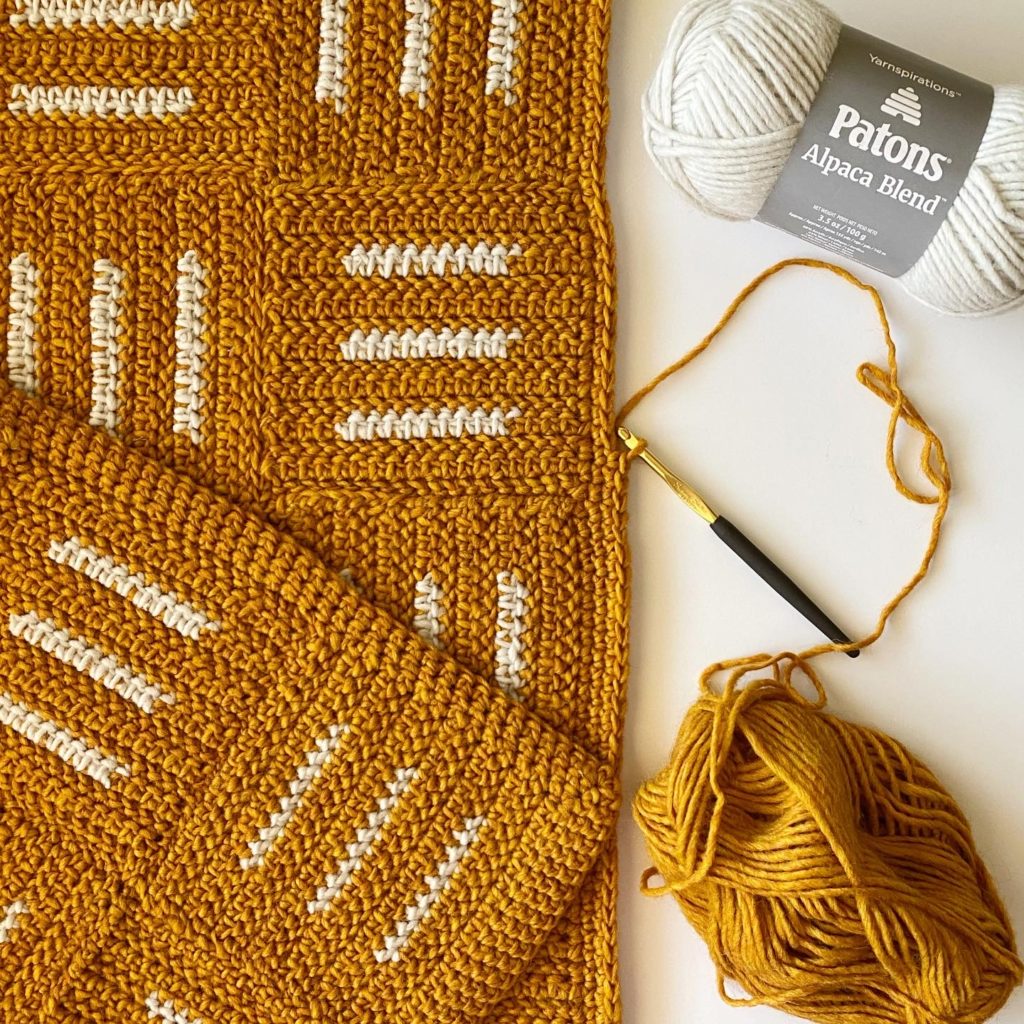 gold and white crochet blanket in progress