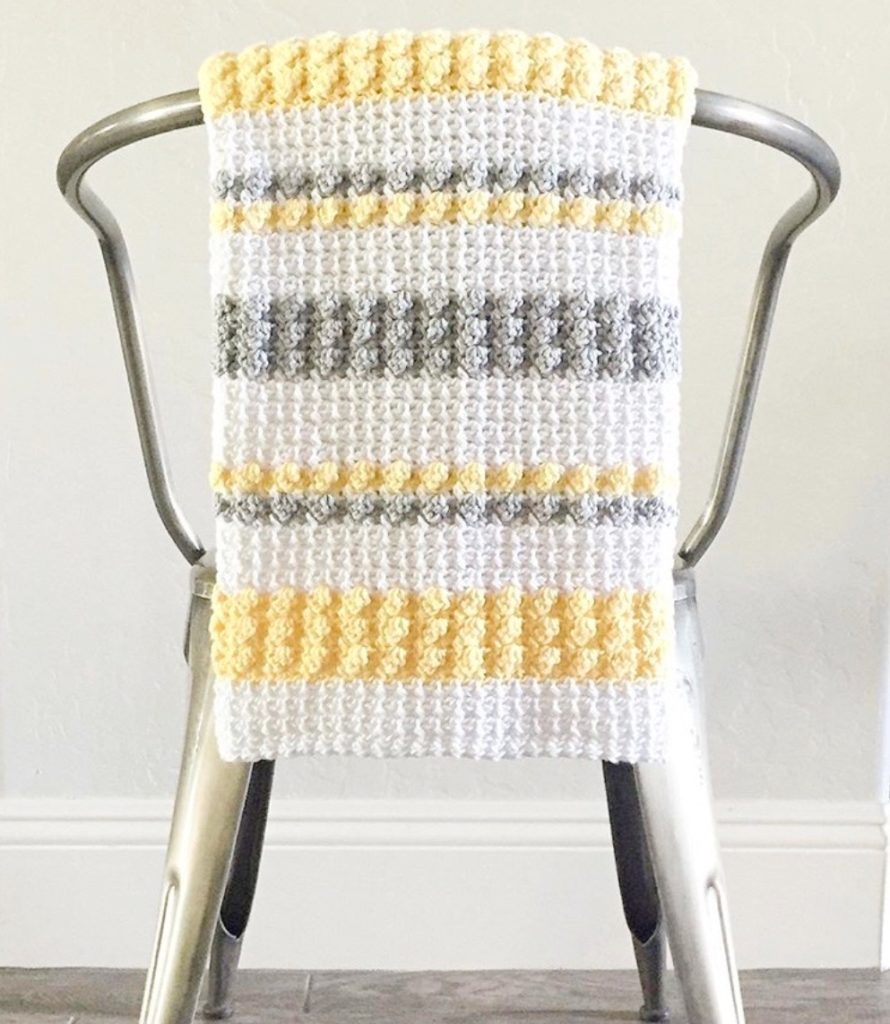 mesh and bobble crochet blanket on chair