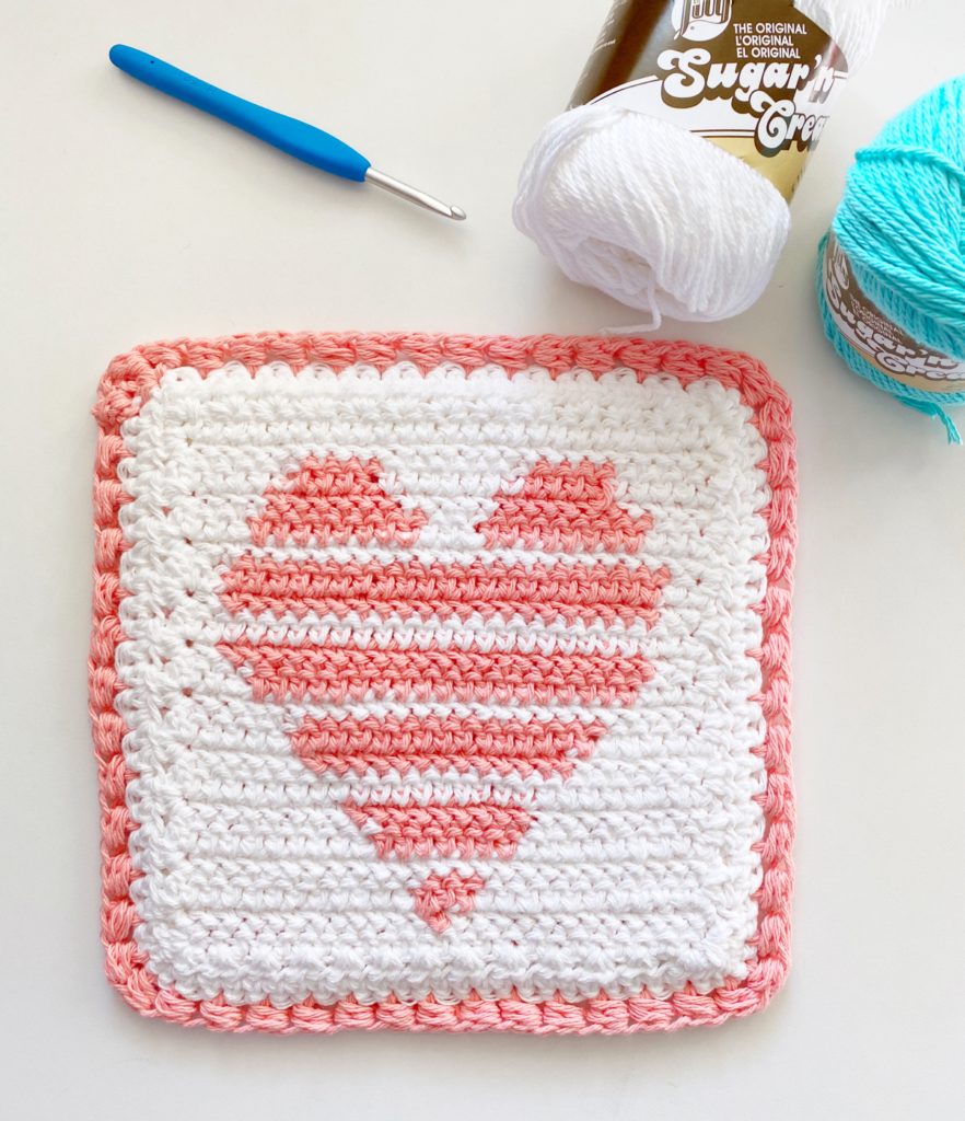heart stripe hot pad on table