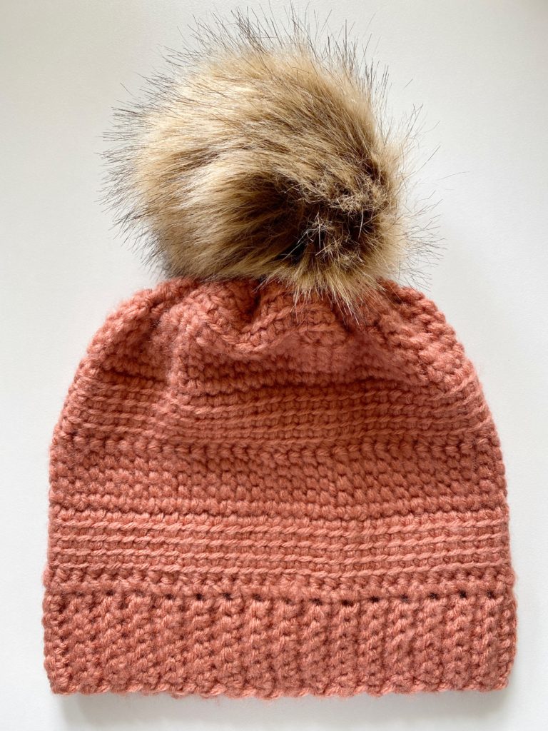 linked stitch crochet hat with fur pom pom