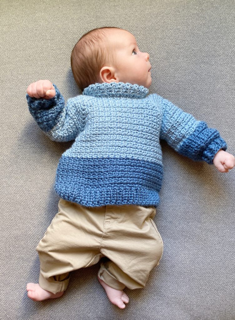 baby in crochet sweater