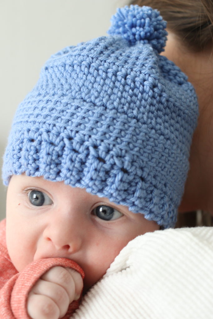 baby in blue crochet hat