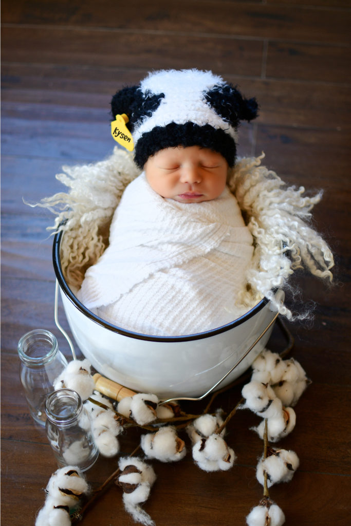baby wearing crochet cow hat