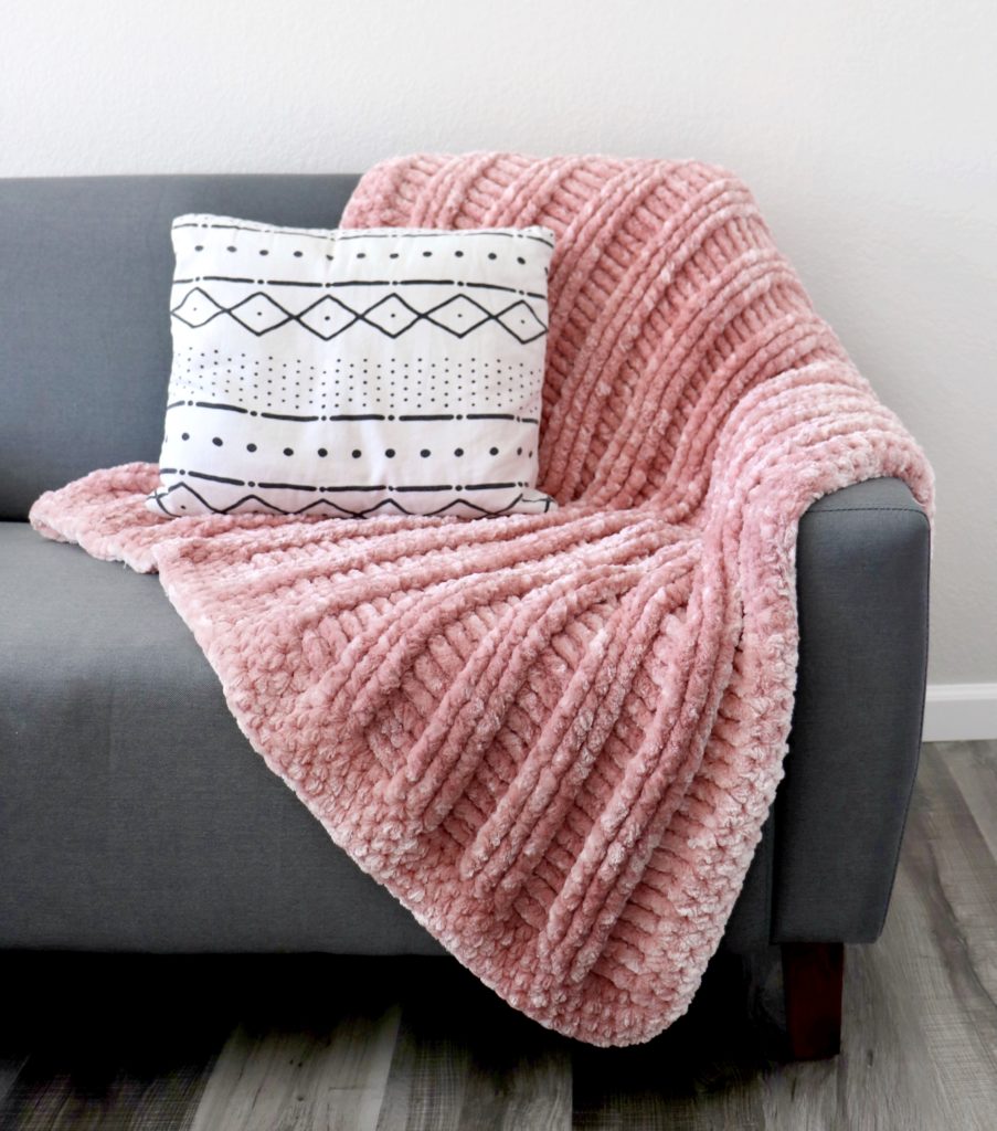 velvet textured crochet blanket on couch