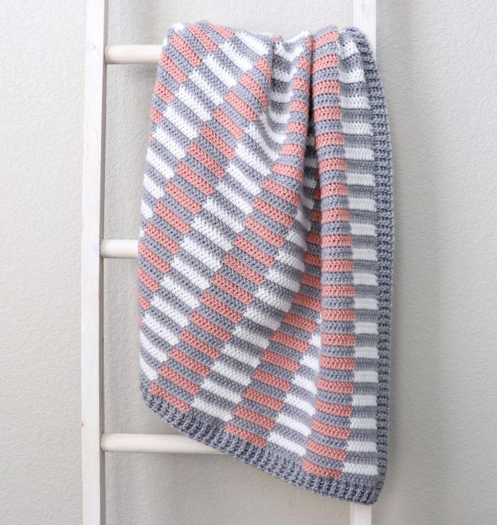 mini half stripe crochet blanket on ladder