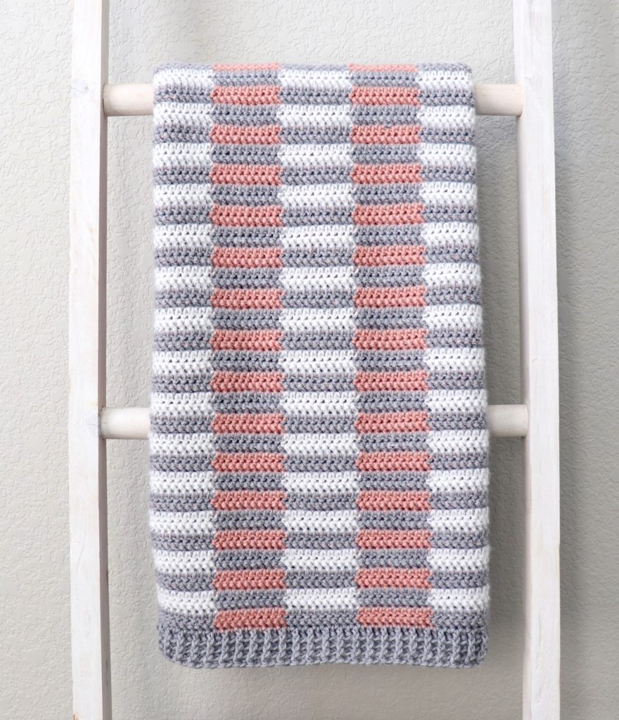 mini half stripe crochet blanket on ladder