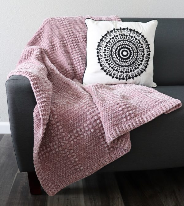 velvet crochet textured windowpane throw on couch
