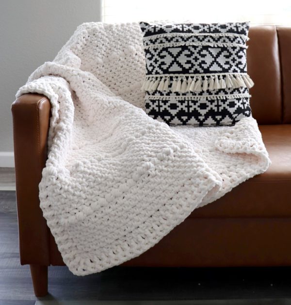 chunky white crochet throw on couch
