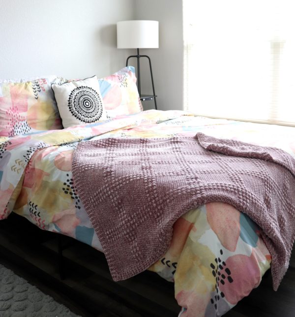 windowpane textured crochet blanket on bed