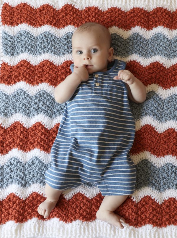 baby laying on ripple crochet blanket