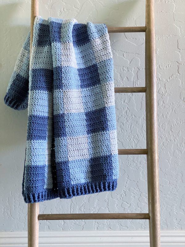 blue crochet gingham blanket on ladder