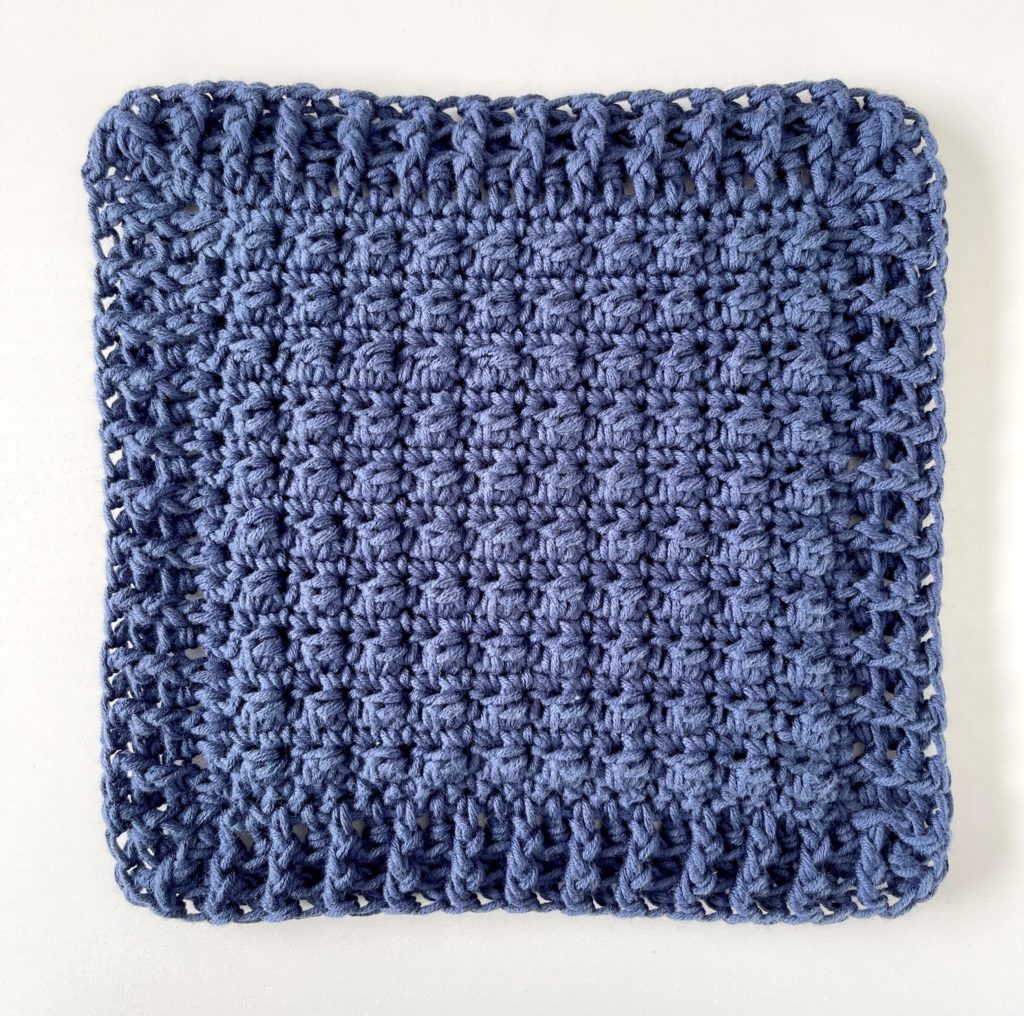 navy crochet hot pad with berry stitch
