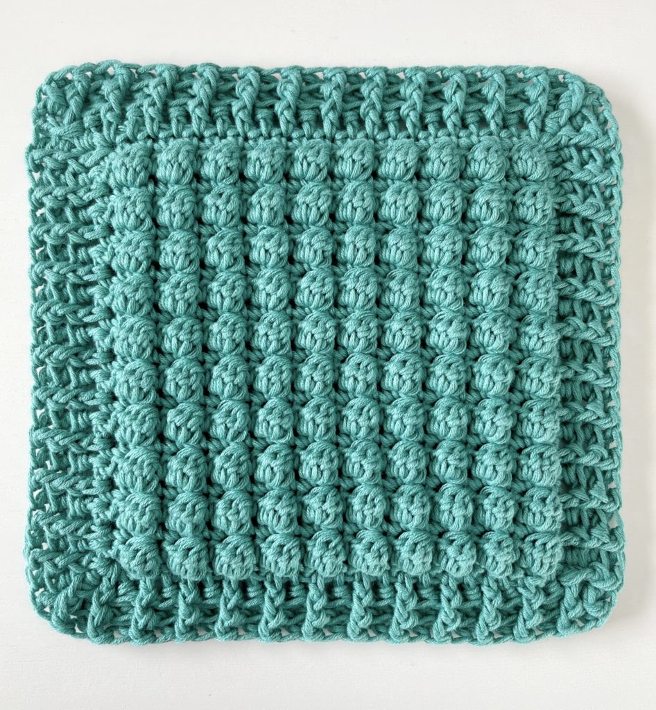 teal crochet hot pad with bobbles