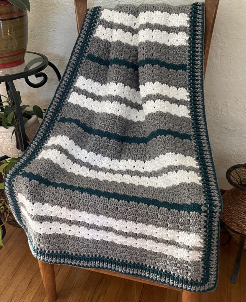 green gray and white crochet blanket