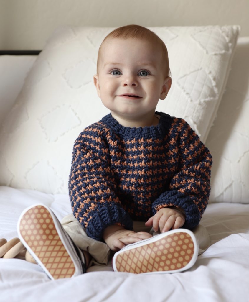 baby boy wearing crochet sweater