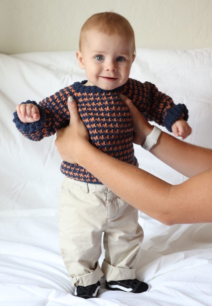 baby boy wearing crochet sweater