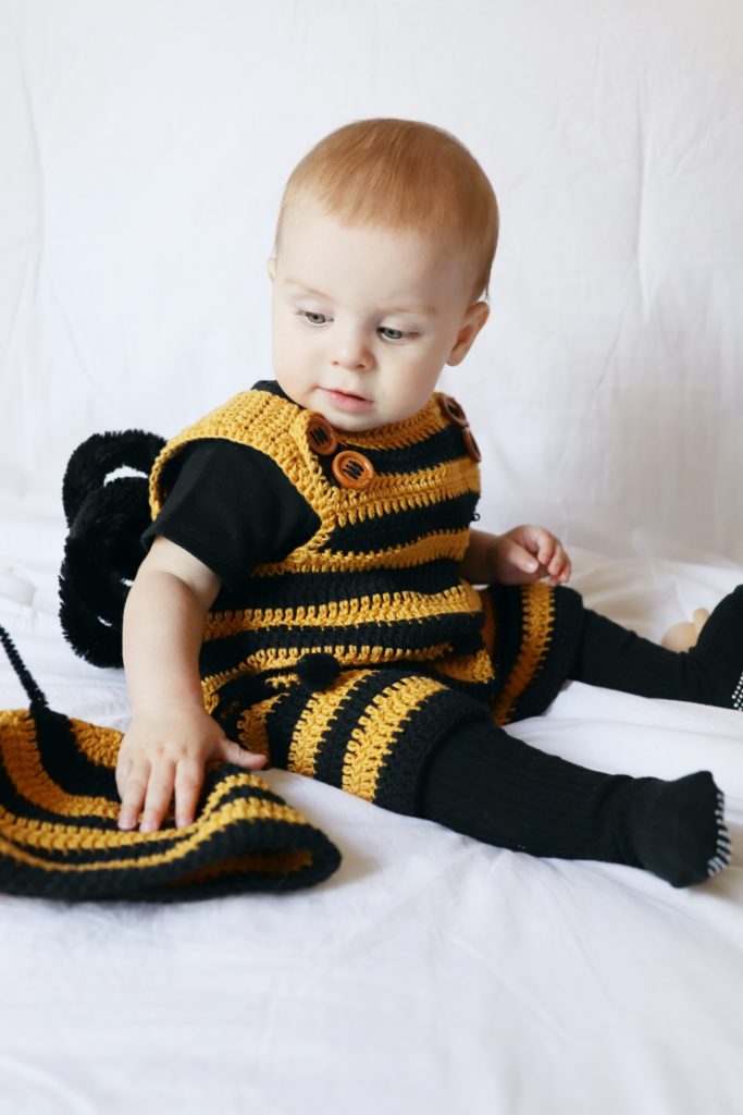 baby boy wearing black and gold striped crochet romper