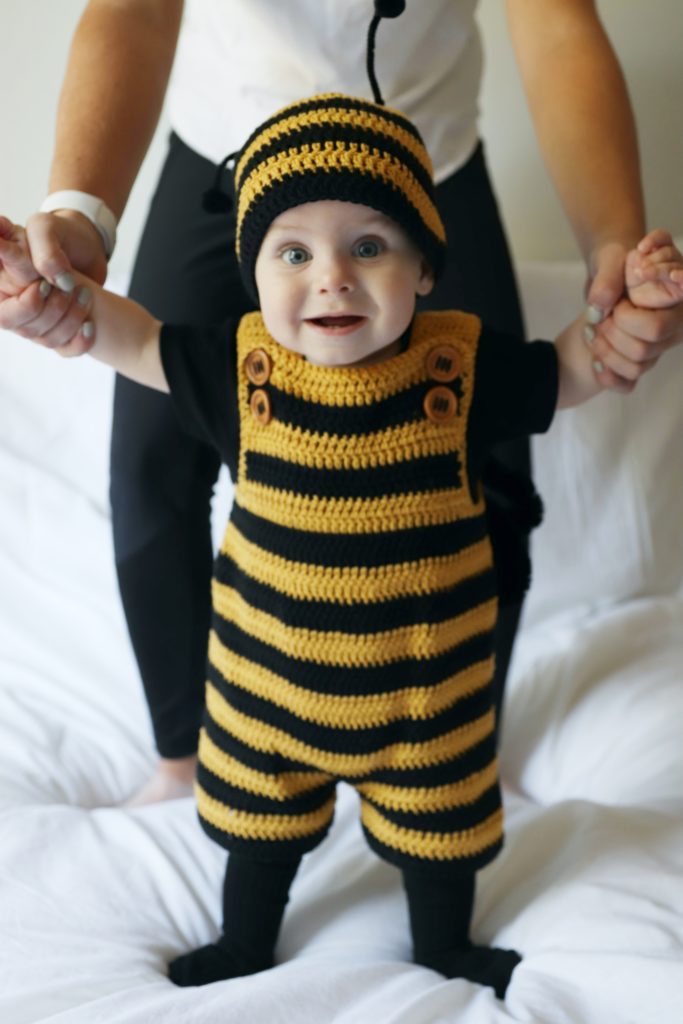 baby boy wearing black and gold striped crochet romper