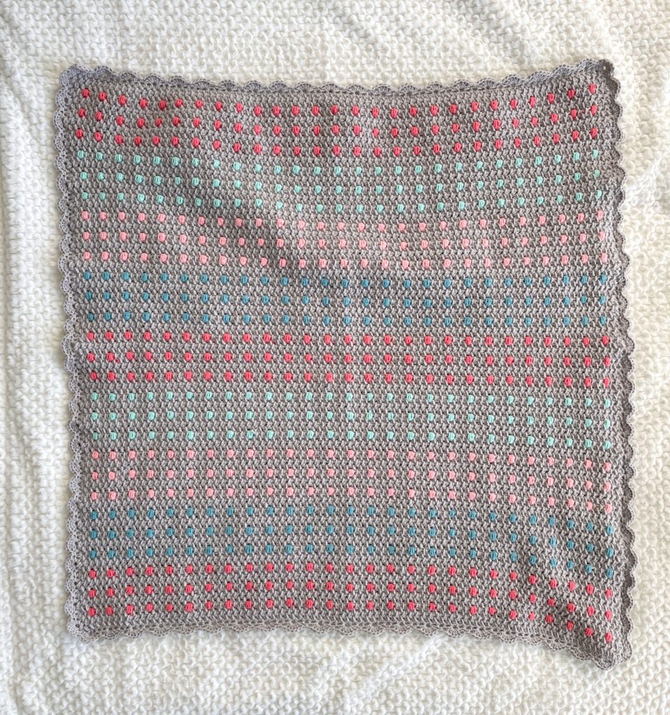 colorful polka dots crochet blanket laying flat